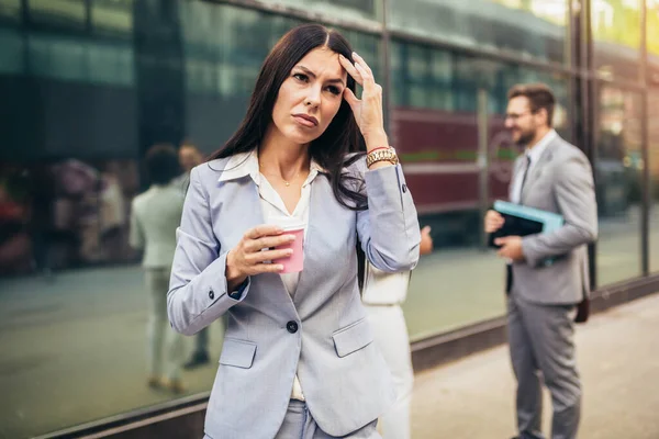 Stressed business woman in the city.