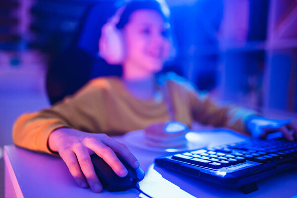 Little boy playing video game in the dark room