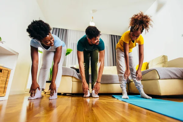 Healthy morning stretching - family doing gymnastic exercise at home