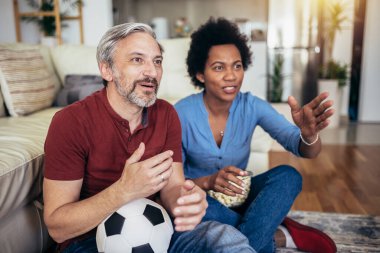 Couple sport fans watching match on television