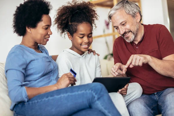 Family Using Digital Tablet Credit Card Home —  Fotos de Stock