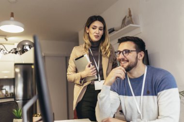 Küçük bir ofiste birlikte iş yapan mutlu çift.