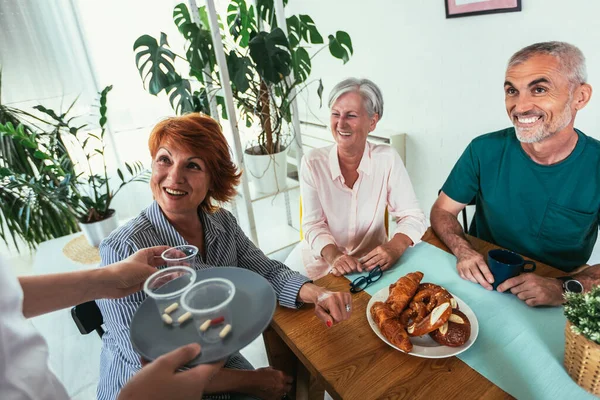 Nurse Giving Medicine Group Seniors Nursing Home — Stock Fotó