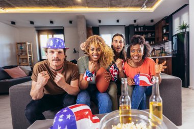 Friends cheering sport league together. Sports Fans Sitting on a Couch Watch Game on TV