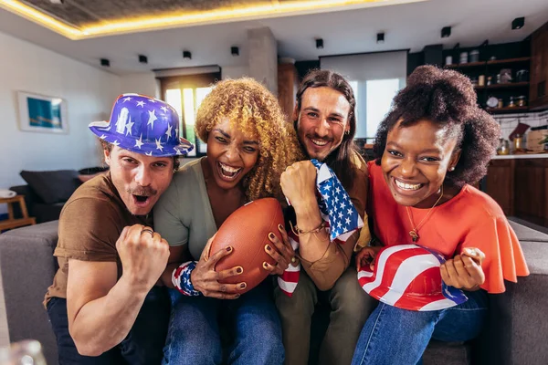Friends cheering sport league together. Sports Fans Sitting on a Couch Watch Game on TV