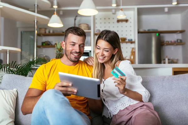 Happy Young Couple Shopping Online Digital Tablet Credit Card Home — Stockfoto