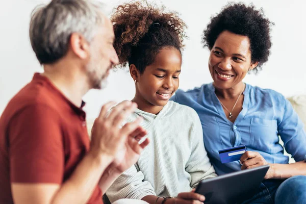 Family Using Digital Tablet Credit Card Home — Stok fotoğraf