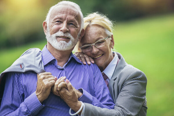 Portrait of beautiful senior couple posing in the park