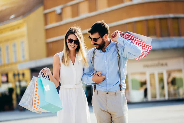 Portrait of happy couple with shopping bags.People,sale,consumerism and lifestyle concept.