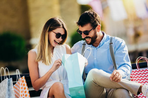 Portrait of happy couple with shopping bags.People,sale,consumerism and lifestyle concept.