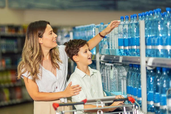 Mother Son Shopping Cart Buying Water Supermarket — Fotografia de Stock