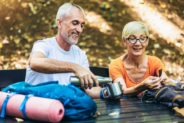 Mature Couple Sitting Drink Coffee While Resting Forest Hiking — Zdjęcie stockowe