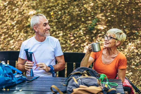 Mature Couple Sitting Drink Coffee While Resting Forest Hiking - Stock-foto