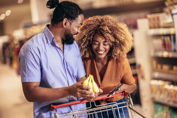 African American Couple Choosing Products Using Phone Grocery Shopping Modern — Stok fotoğraf