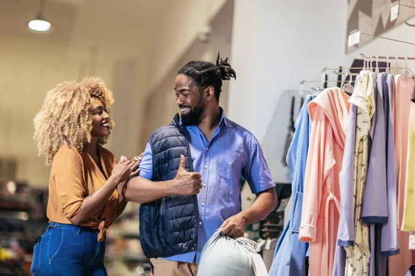 Young african american couple buying clothes 