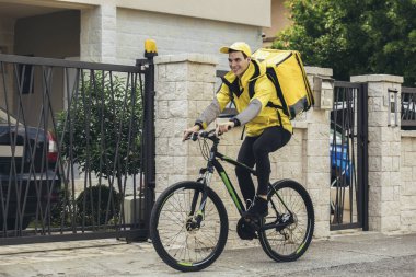 Bisikletli erkek kurye paket teslim ediyor.