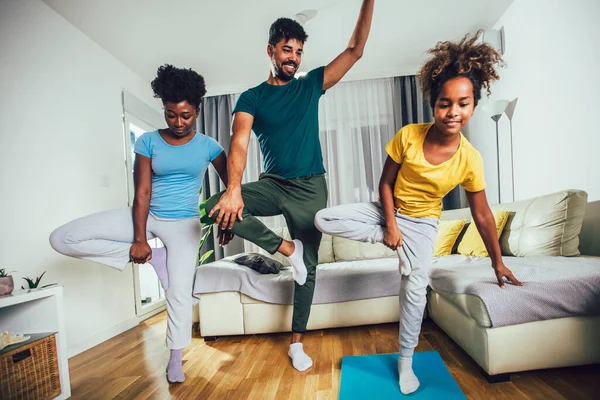 Healthy morning stretching - family doing gymnastic exercise at home