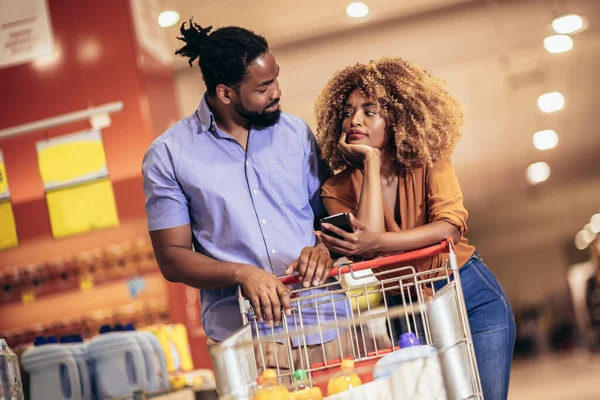 African American Couple Choosing Products Using Phone Grocery Shopping Modern — Foto Stock