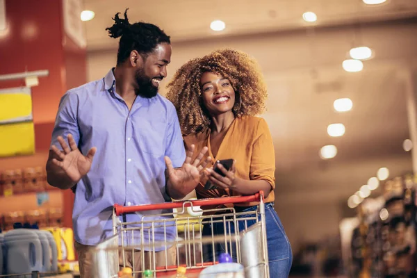 African American Couple Choosing Products Using Phone Grocery Shopping Modern — ストック写真