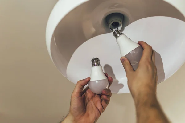 Man Changing Light Bulb His Home — Stock Photo, Image