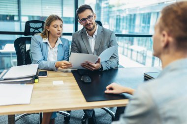 Human resource team talking to a candidate during a job interview in the office.