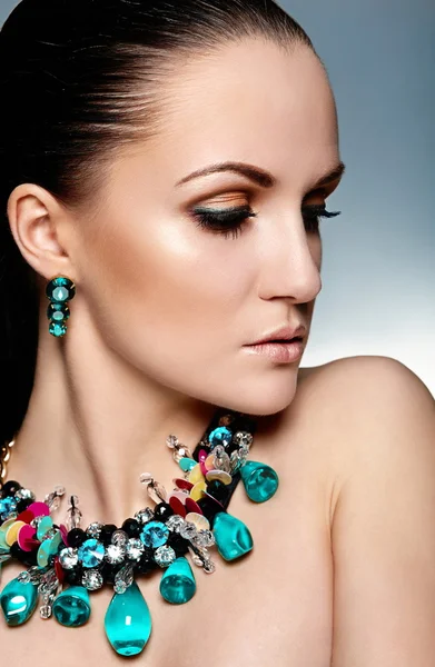 High fashion look.glamor closeup portrait of beautiful sexy brunette Caucasian young woman model with healthy hair,bright makeup, with perfect clean skin with green accessory jewelery — Stock Photo, Image