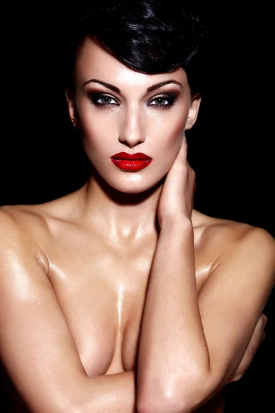 High fashion look.glamor portrait of beautiful sexy Caucasian young brunette nude woman model with bright makeup with red lips on black background with perfect wet body — Stock Photo, Image