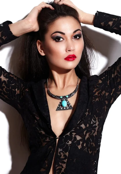 High fashion look.glamor closeup portrait of beautiful sexy stylish brunette Caucasian young woman model with bright makeup, with red lips, with perfect clean skin with jewelery in black cloth — Stock Photo, Image