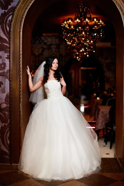 Happy beautiful sexy bride brunette girl woman in white wedding dress with hairstyle and bright makeup in interior — Stock Photo, Image