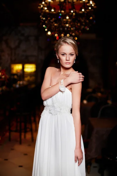 Happy beautiful sexy bride blond girl woman in white wedding dress with hairstyle and bright makeup in interior — Stock Photo, Image