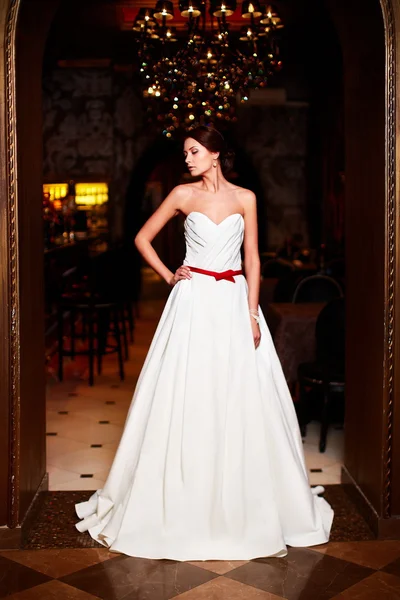 Happy beautiful sexy bride brunette girl woman in white wedding dress with hairstyle and bright makeup in interior — Stock Photo, Image