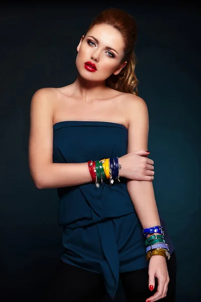 High fashion look.glamor close seup portrait of beautiful sexy stylish blond Caucasian young woman model with bright makeup, with red lips, with perfect clean skin with colorful accessories in blue cloth — стоковое фото