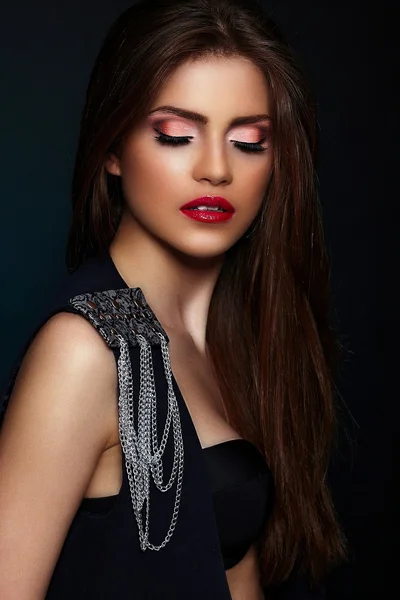 High fashion look.glamor closeup portrait of beautiful sexy stylish brunette Caucasian young woman model with bright makeup, with red lips, with perfect clean skin with jewelery in black cloth — Stock Photo, Image