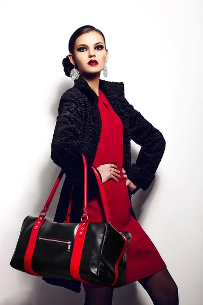 High fashion look.glamor closeup portrait of two beautiful sexy stylish brunette Caucasian young woman model in black jacket with bag bright makeup, with perfect clean skin in studio — Stock Photo, Image