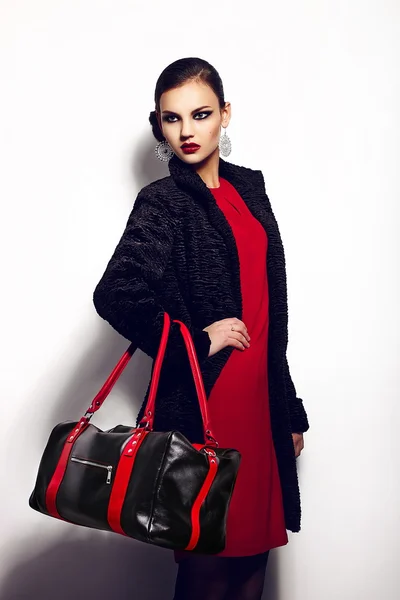 High fashion look.glamor close seup portrait of two beautiful sexy stylish brunette Caucasian young woman model in black jacket with bag bright makeup, with perfect clean skin in studio — стоковое фото