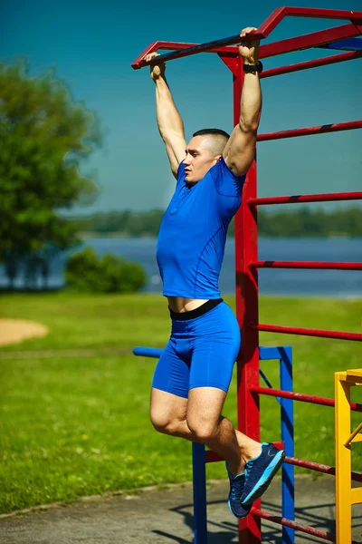 Guapo saludable feliz srtong atleta hombre masculino haciendo ejercicio en el parque de la ciudad — Foto de Stock