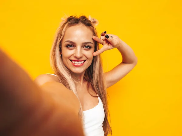 流行の夏服の若い美しい笑顔ブロンドの女性 スタジオで黄色の壁の近くにポーズを取るセクシーな屈託のない女性 室内で楽しんでいる積極的なモデル 陽気で幸せ ポルノ自画撮り — ストック写真