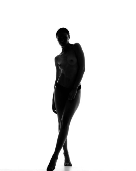 Back and white silhouette of female nude profile white background. Young Elegant Sexy Woman. Girl with naked body.