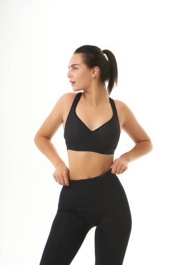Perfect slim tanned young female body in sportswear. Concept perfect body, no fat, motivation, healthy lifestyle, fitness routine. Isolated white background. 