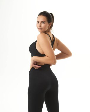 young slim woman posing in underwear and leggings. female back, buttocks. Concept beauty, body and skin care, medicine, health, spa, cosmetics,