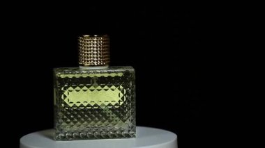 footage of glass perfume bottle dark background