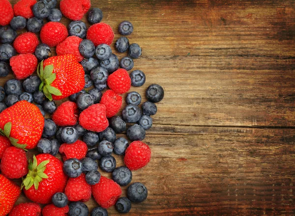 Berries on wooden background