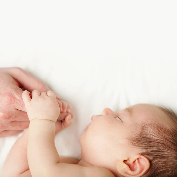 Baby holding father's hand — Stock Photo, Image