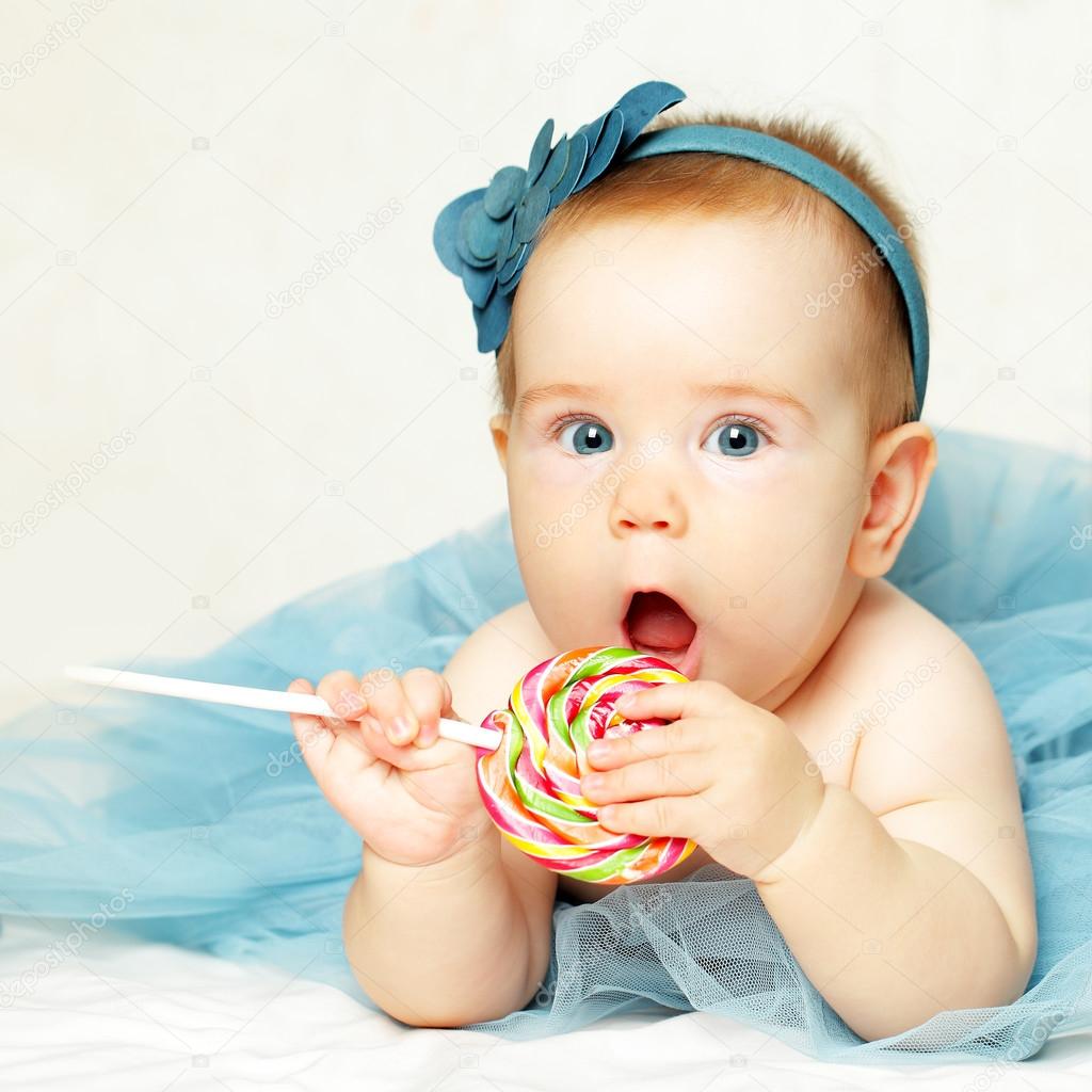 Baby girl eating lollipop