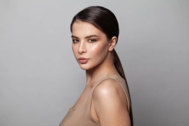 Temiz tenli, stüdyo portresi olan genç ve güzel bir kadın. Yüz bakımı, kozmetoloji, güzellik ve kaplıca