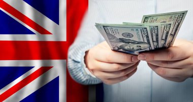 UK national flag and US dollars banknote. Business, finance, politics and corruption concept