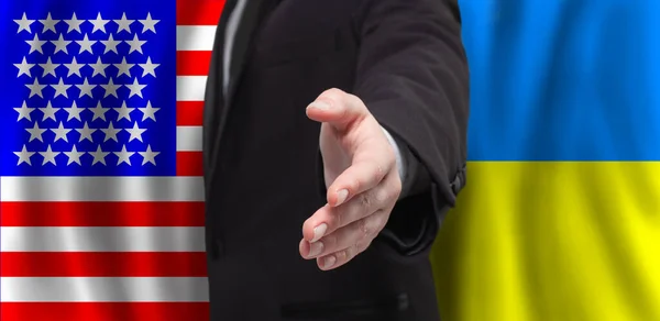 Businessman or Politics hand against USA and Ukraine flags