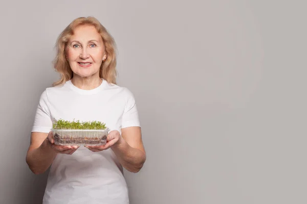 Felice Donna Anziana Che Tiene Cibo Vegetariano Microverde Sfondo Grigio — Foto Stock