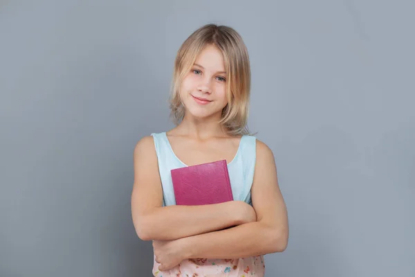 Happy School Girl Holding Book Smiling Gray Studio Wall Background — Stock Photo, Image