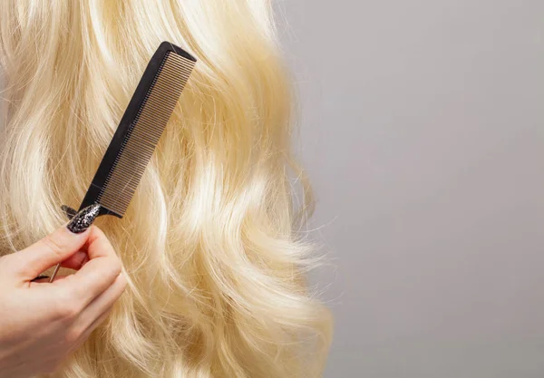 Hair Care Concept Black Comb Long Curly Blonde Hair Gray — Stock Photo, Image